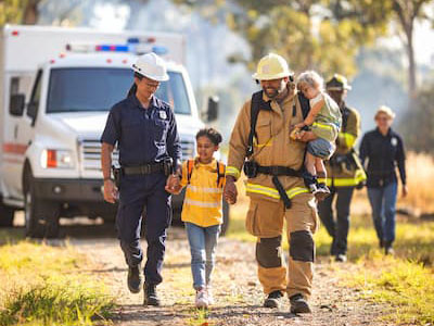 Family evacuating with go bags during a wildfire